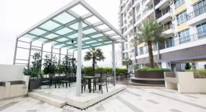 a patio with tables and chairs in a building at Ipoh Majestic R&C Homestay 2 & 3 in Ipoh