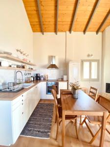 a kitchen with a wooden table and a wooden ceiling at Aelio in Raches