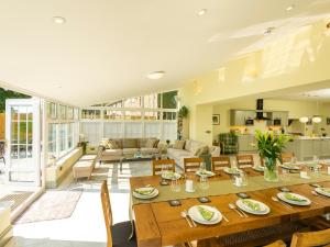 a large living room with a large wooden table at Old Rectory House in Newtown