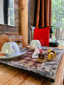 a table with plates and dishes on a table at Kaoko Mopane Lodge & Campsite in Opuwo