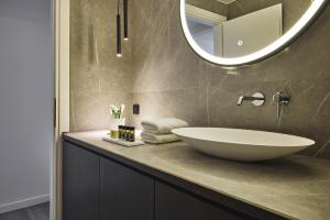 a bathroom with a sink and a mirror at Acropolis Panorama Residence in Athens +33 photos