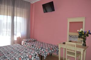 Postel nebo postele na pokoji v ubytování Hotel Torvaianica