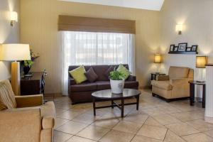 a living room with a couch and a table at Sleep Inn & Suites Bakersfield North in Bakersfield