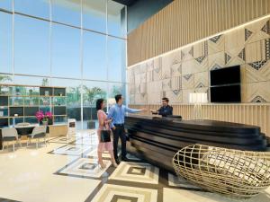 a group of people standing in a lobby at Mercure Makassar Nexa Pettarani in Makassar