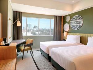 Mercure Makassar Nexa Pettarani客房内的一张或多张床位