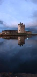 a castle in the middle of a body of water at The Fuzzy Duck in Broughty Ferry