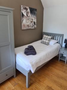 a bedroom with a bed with a towel on it at The Finch Hatton Arms in Sleaford