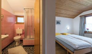 a bedroom with a bed and a bathroom at B&B Pranzaira in Vicosoprano