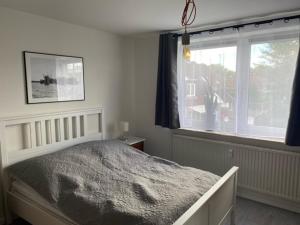 a bedroom with a large bed and a window at Business-Apartment Boltentor in Emden