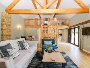 a living room with a couch and a table at Petals Patch in Cheltenham