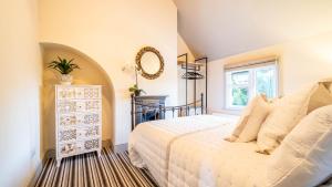 a bedroom with a bed and a mirror on the wall at Available For Contractors 2 Double Beds and Sofa Bed Private Parking in Harlow