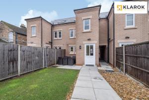 an image of a house with a fence at LONG STAYS 30pct OFF - Spacious 4Bed - Sports Channels - Parking By Klarok Short Lets & Serviced Accommodation in Peterborough