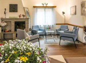 a living room with chairs and a fireplace at B&B Pranzaira in Vicosoprano