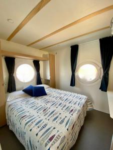 a bedroom with two windows in an airplane at Blue Village in Savigliano