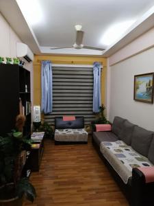 a living room with a couch and a table at 1511 Guest House in Melaka