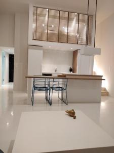 a kitchen with a table and chairs on a white floor at Fourteen All Seasons House in Chania