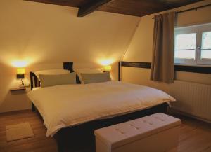 a bedroom with a large bed and a window at Hof von Felde in Soltau