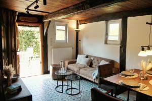 a living room with a couch and a table at Hof von Felde in Soltau