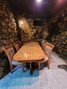 a wooden table and chairs in a room at Holiday House in Yerevan with Garden and Lovely Views in Yerevan