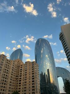 a group of tall buildings in a city at Budget One Room Apartment in Baku