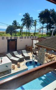 a resort with a swimming pool and palm trees at Pousada Lua Vermelha in Caponga