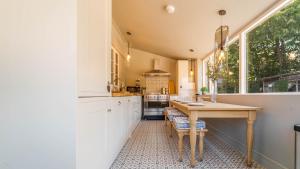 a kitchen with a wooden table and a window at Available For Contractors 2 Double Beds and Sofa Bed Private Parking in Harlow