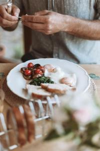 a person cutting a plate of food on a table at Mossie's in Adrigole