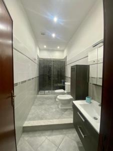 a bathroom with a shower and a toilet and a sink at Marechiaro Apartments in Palermo +30 photos