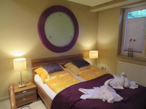 a bedroom with two beds and a mirror on the wall at Apartament Flores 1 in Mielno