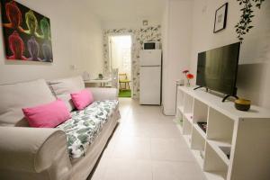 a living room with a couch and a television at Sweet Home Apartaments in El Médano