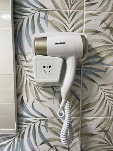a hair dryer on a wall in a bathroom at BeB sott o pont Napoli in Naples