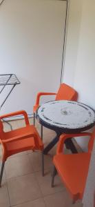 three chairs and a table and a table and chairs at Apartments Nebojša in Soko Banja