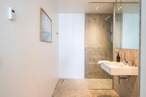 a bathroom with a sink and a shower at The Pier Ateliers by Daniel&Jacob's in Copenhagen