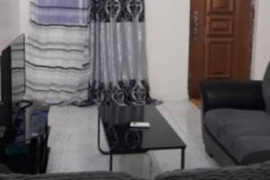 a living room with a couch and a coffee table at Bambino Guest House in Brikama