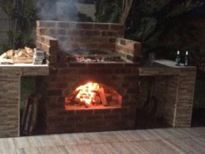 een bakstenen oven met een vuur erin bij The Holiday Home on the Beach in Port Shepstone