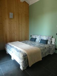 a bedroom with a bed with a wooden wall at Ca' San Michele in Asti