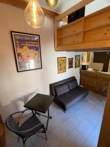 a living room with a couch and a table at Le Hameau du Buron - "La Taverne" - Option SPA in Eyzin-Pinet