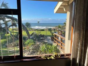 a window view of the beach from a house at The Beach House in Port Shepstone