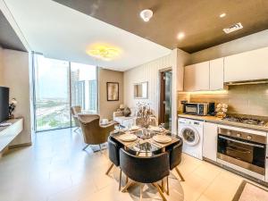 - une cuisine et une salle à manger avec une table et des chaises dans l'établissement STAY BY LATINEM Luxury 2BR Holiday Home CV B1309 Near Burj Khalifa, à Dubaï