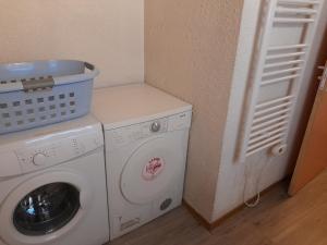 a washer and dryer in a corner of a room at Madahouse in Gap