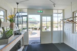 a garage entry with a door and a patio at Herberg de Loohoeve in Schoonloo