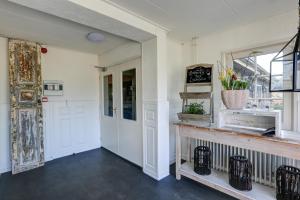 a room with a door and a counter with a window at Herberg de Loohoeve in Schoonloo