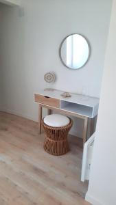 a white desk with a mirror and a stool at Le Soleya - Centre village - Piscine - 2 pers in Bessan