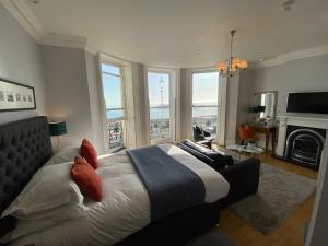 a bedroom with a bed with a view of the city at A Room With A View in Brighton & Hove