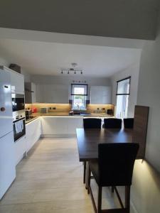 a large kitchen with a table and a dining room at Fort William Lovely Flat Central location in Fort William