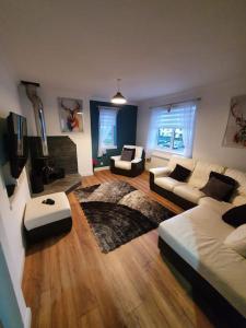 a large living room with a couch and a table at Fort William Lovely Flat Central location in Fort William