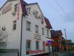 a white building with a sign for a hotel at Hotel Kiev-S in Zhashkiv