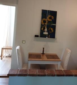 a dining room with a table and white chairs at Ferienwohnung Jeannette I in Hasselfelde