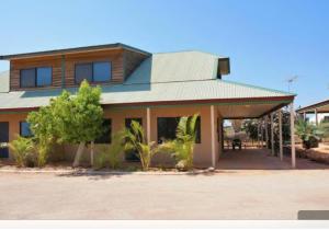 a house with a gambrel roof on top of it at The Ningaloo breeze villa 5 in Exmouth