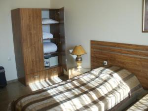 a bedroom with a bed with a wooden headboard at Deluxe Room in Stoykite in Pamporovo